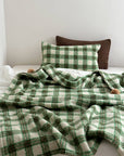 Refined Plaid Faux Lambswool Throw Blanket with Pom-Poms – Cozy & Stylish Home Décor