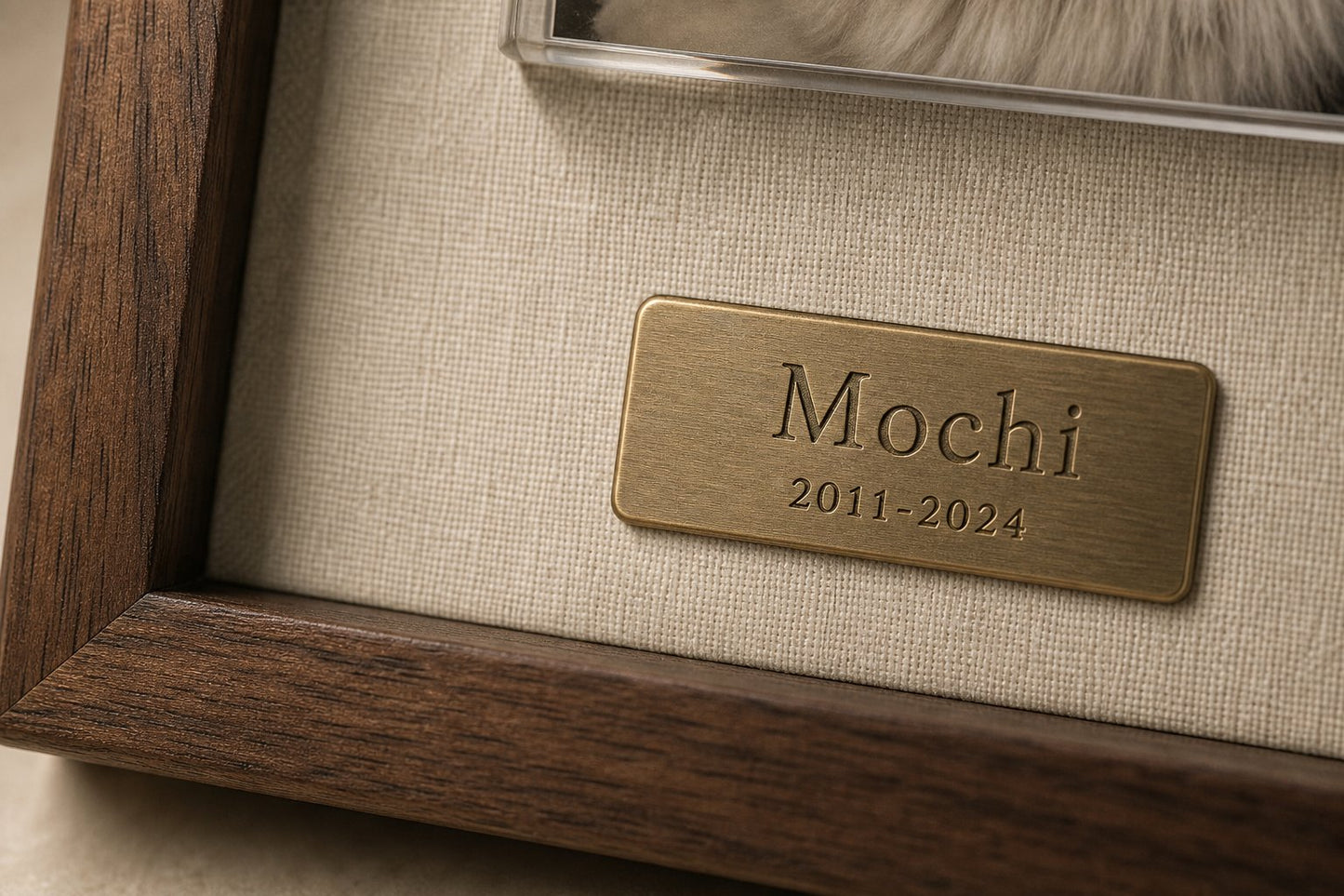 Close-up of the engraved brass nameplate on linen backing