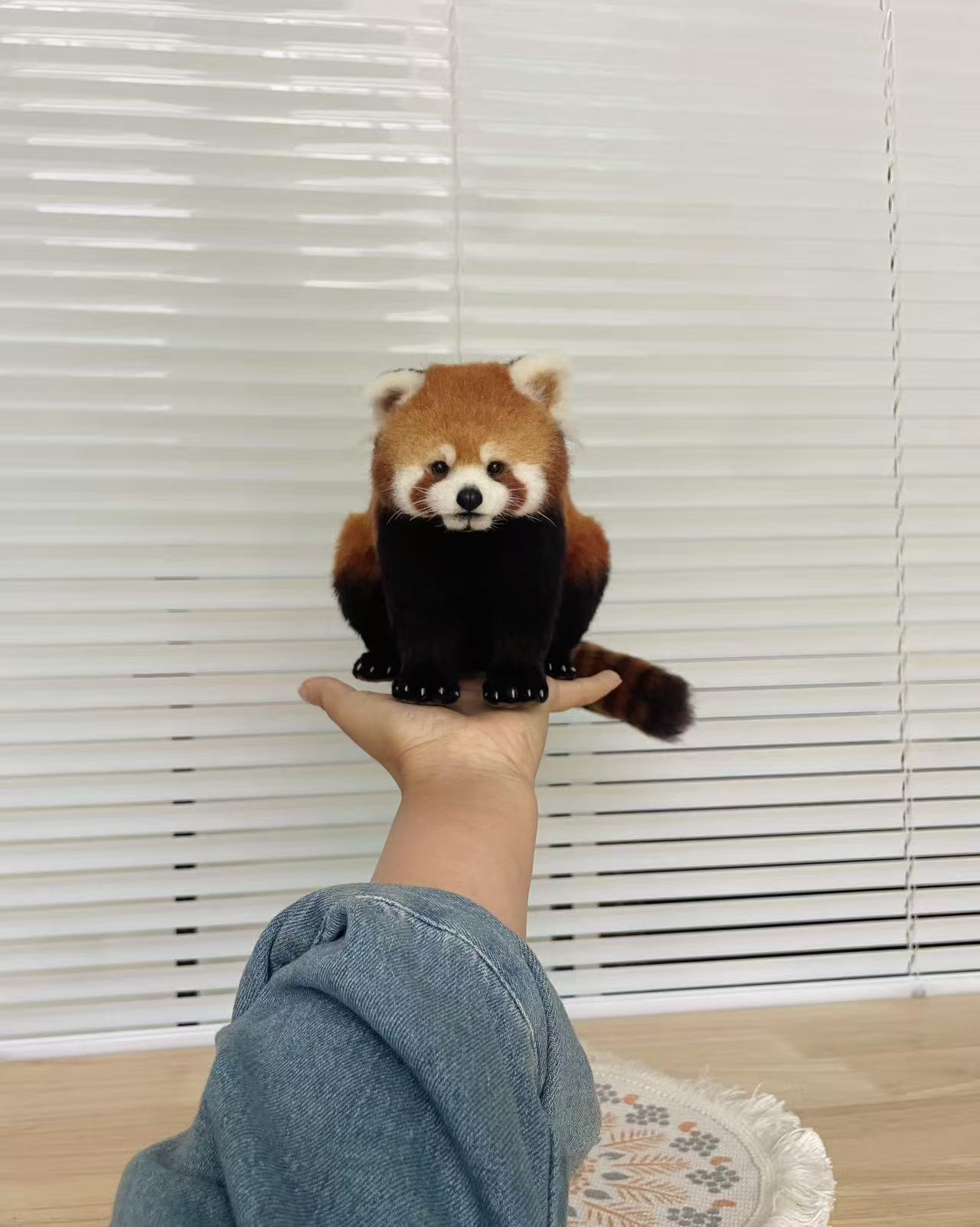 Premium full-body wool felt red panda replica held in one hand