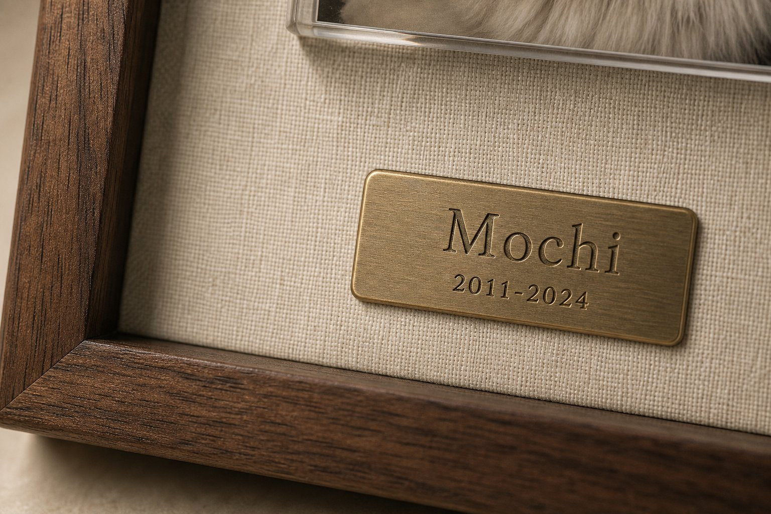 Close-up of the engraved brass nameplate on linen backing