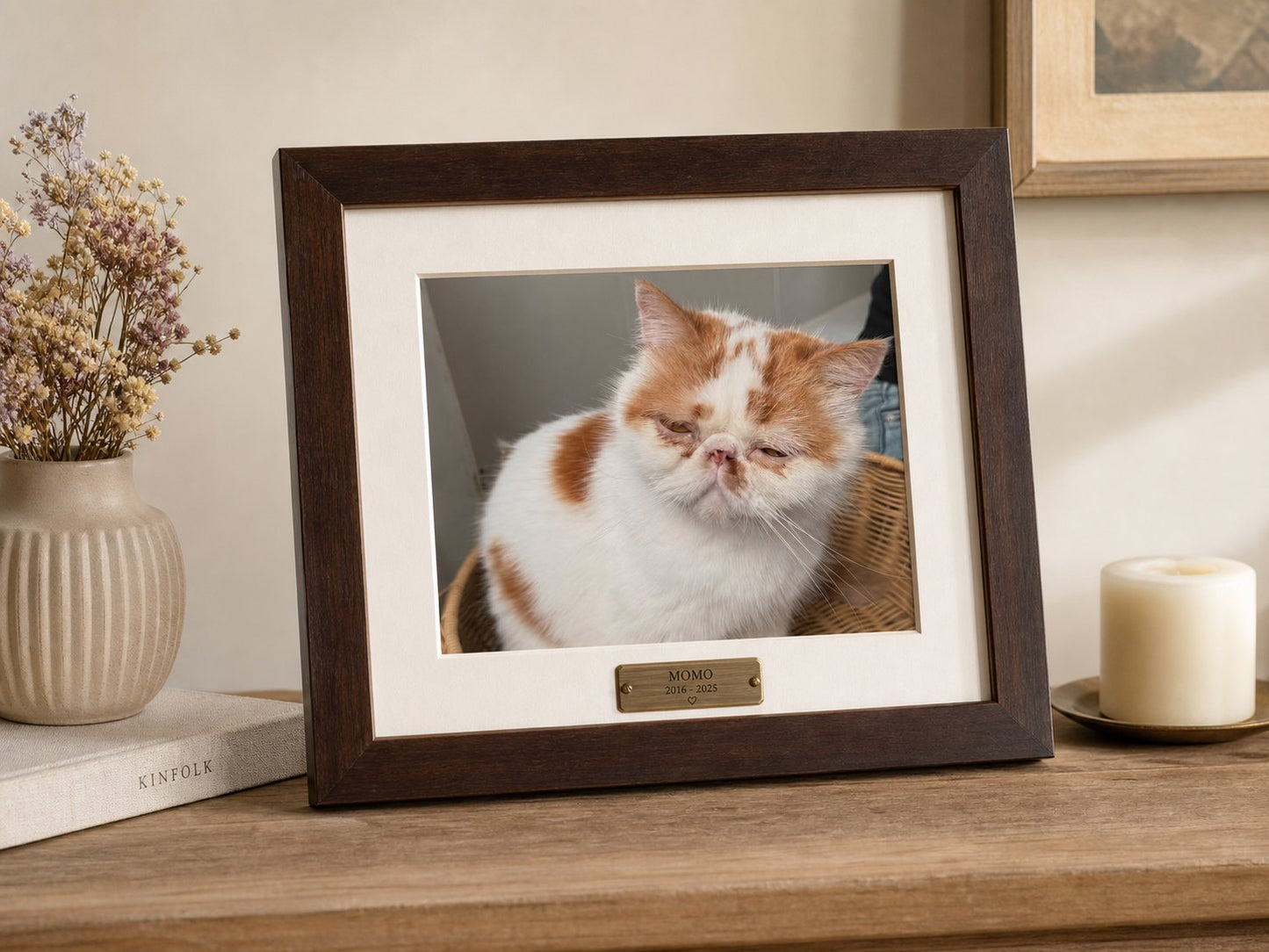 Walnut memorial frame displayed on a wooden console in warm light